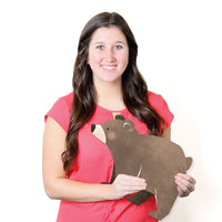Woman holding a bear-shaped yard sign against a white background