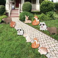 Woodland animal cutouts yard signs for baby shower on grass and pathway in front of a house