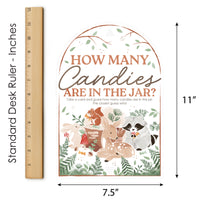 Woodland-themed game card with animals and text, shown with a ruler for scale.