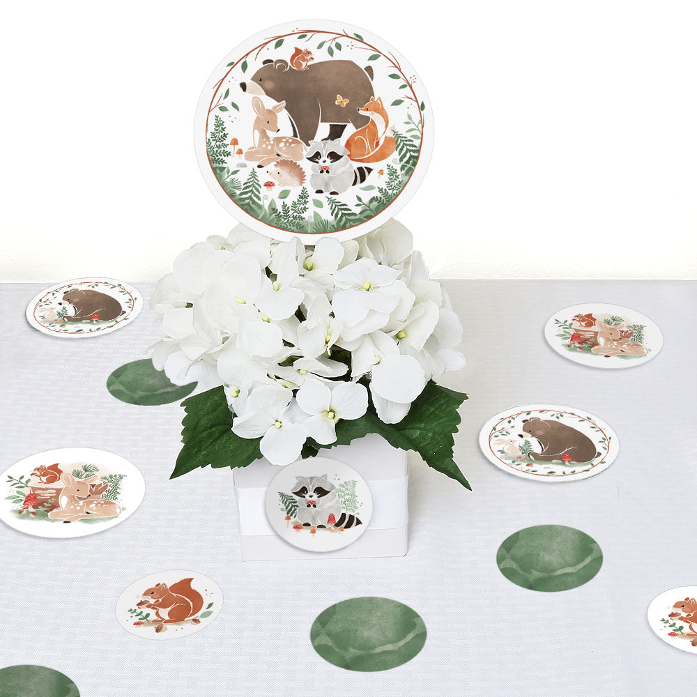 Table setting with animal-themed coasters and a floral centerpiece on a white tablecloth.
