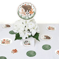 Table setting with animal-themed coasters and a floral centerpiece on a white tablecloth.