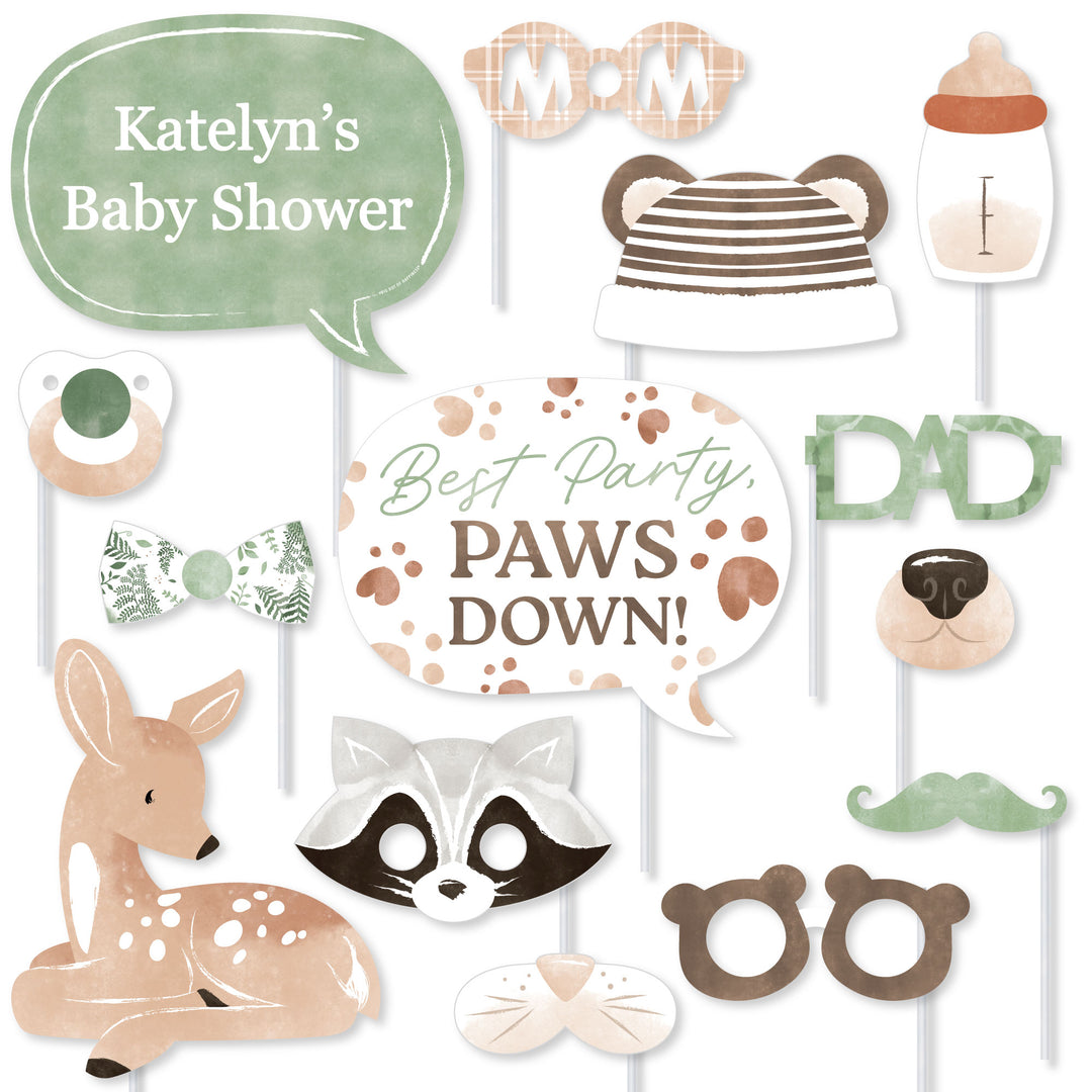 Woodland-themed baby shower photo booth props with animal faces and text.