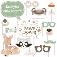 Woodland-themed baby shower photo booth props with animal faces and text.