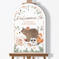 Woodland animal-themed baby shower sign on an easel with 'Welcome to Katelyn's Baby Shower' text.