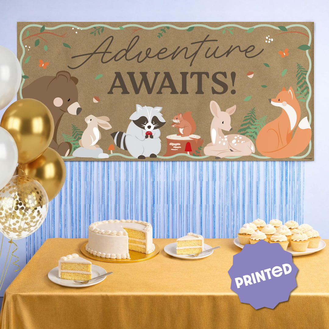 Adventure Awaits woodland banner styled at forest themed party