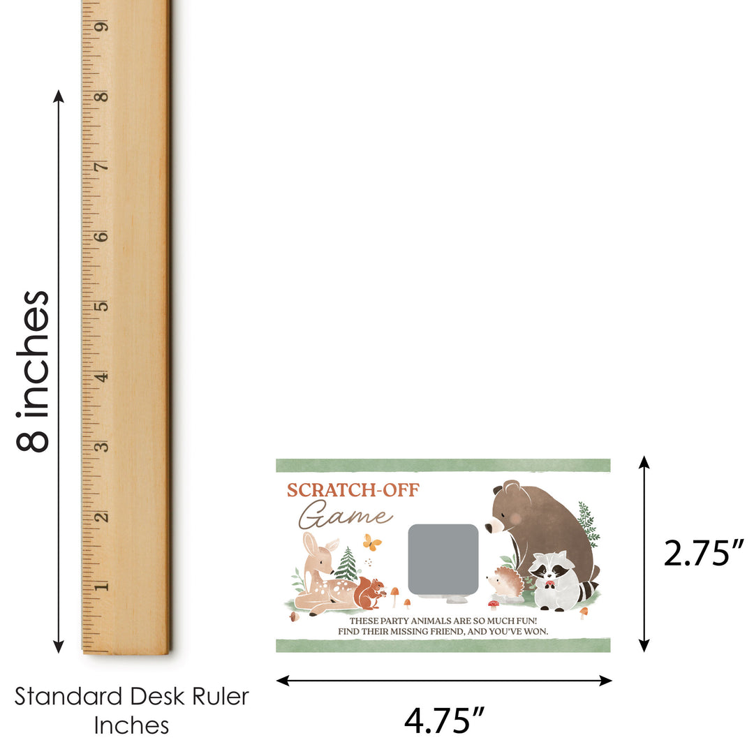 Scratch-off game with forest animals design next to a standard desk ruler for size reference.
