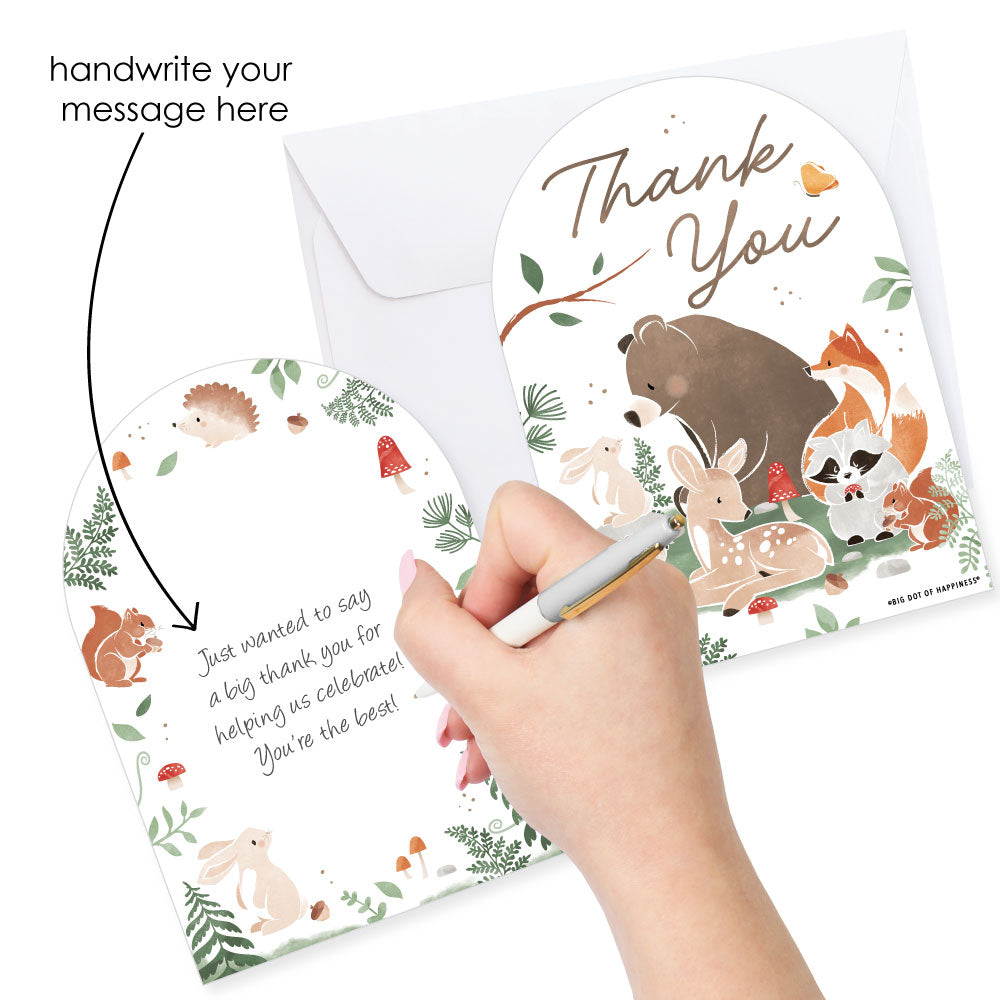 Woodland animal-themed thank you card with a hand writing on it, accompanied by an envelope.