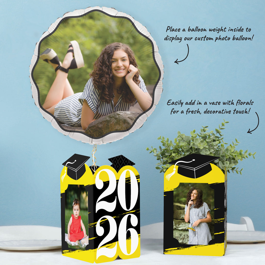 Yellow graduation party table with photo holder decor