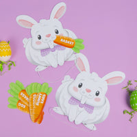 Two paper bunny headband game cutouts with Easter-themed guessing cards on a purple background