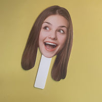Custom fun face paddles on a yellow background