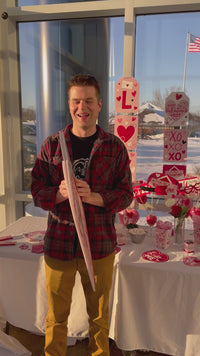 Man opening up a giant valentines day card
