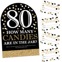 A black and gold party game sign with the number 80 and text that reads 'How many candies are in the jar?' along with 40 guess cards, for a birthday party game.