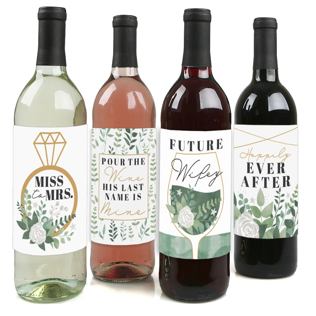 Four wine bottles each with a different wine color and a unique greenery-themed label sticker representing various stages of bridal life.