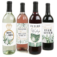 Four wine bottles each with a different wine color and a unique greenery-themed label sticker representing various stages of bridal life.