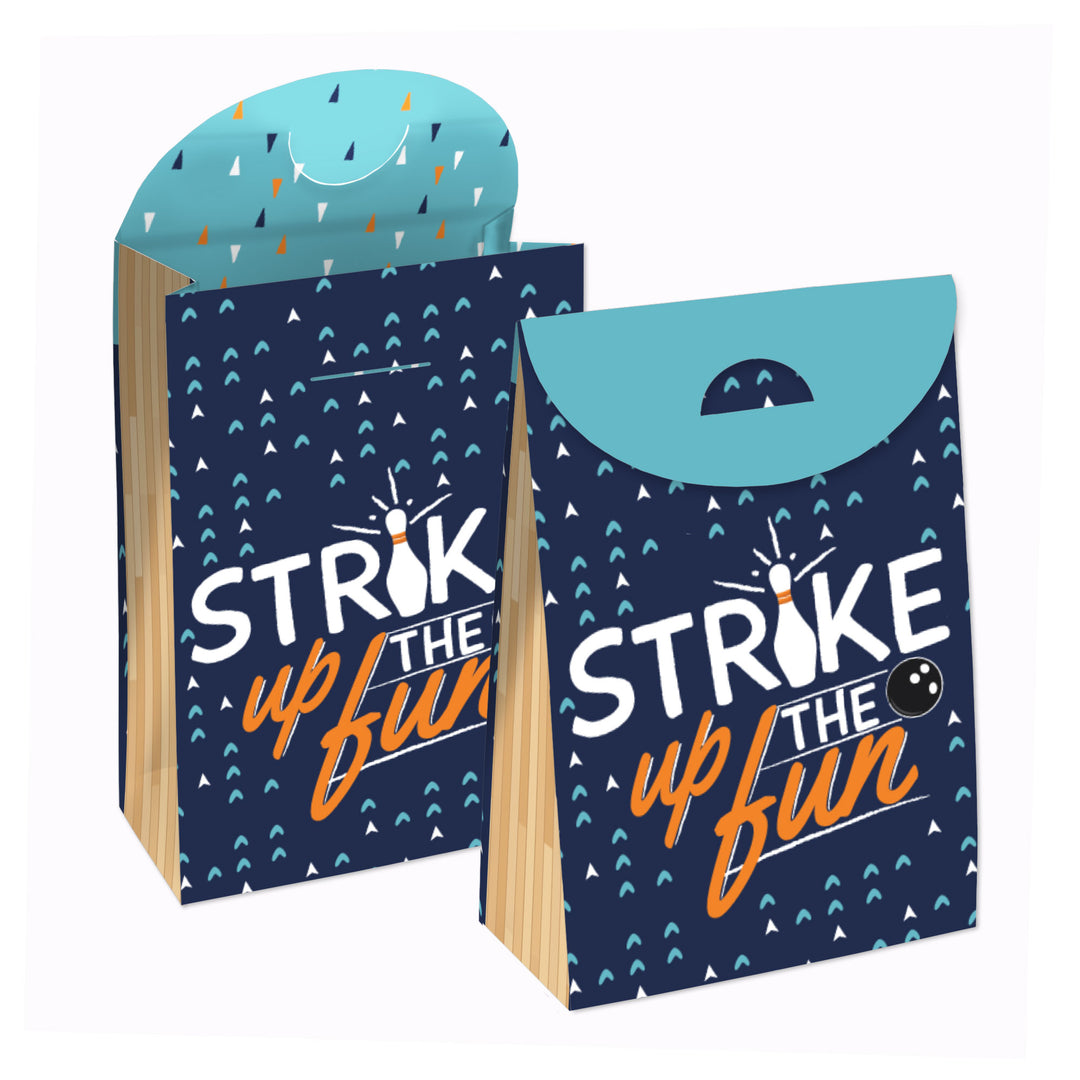 Two blue party favor bags with 'STRIKE UP THE FUN' text and bowling ball imagery, designed to be assembled.