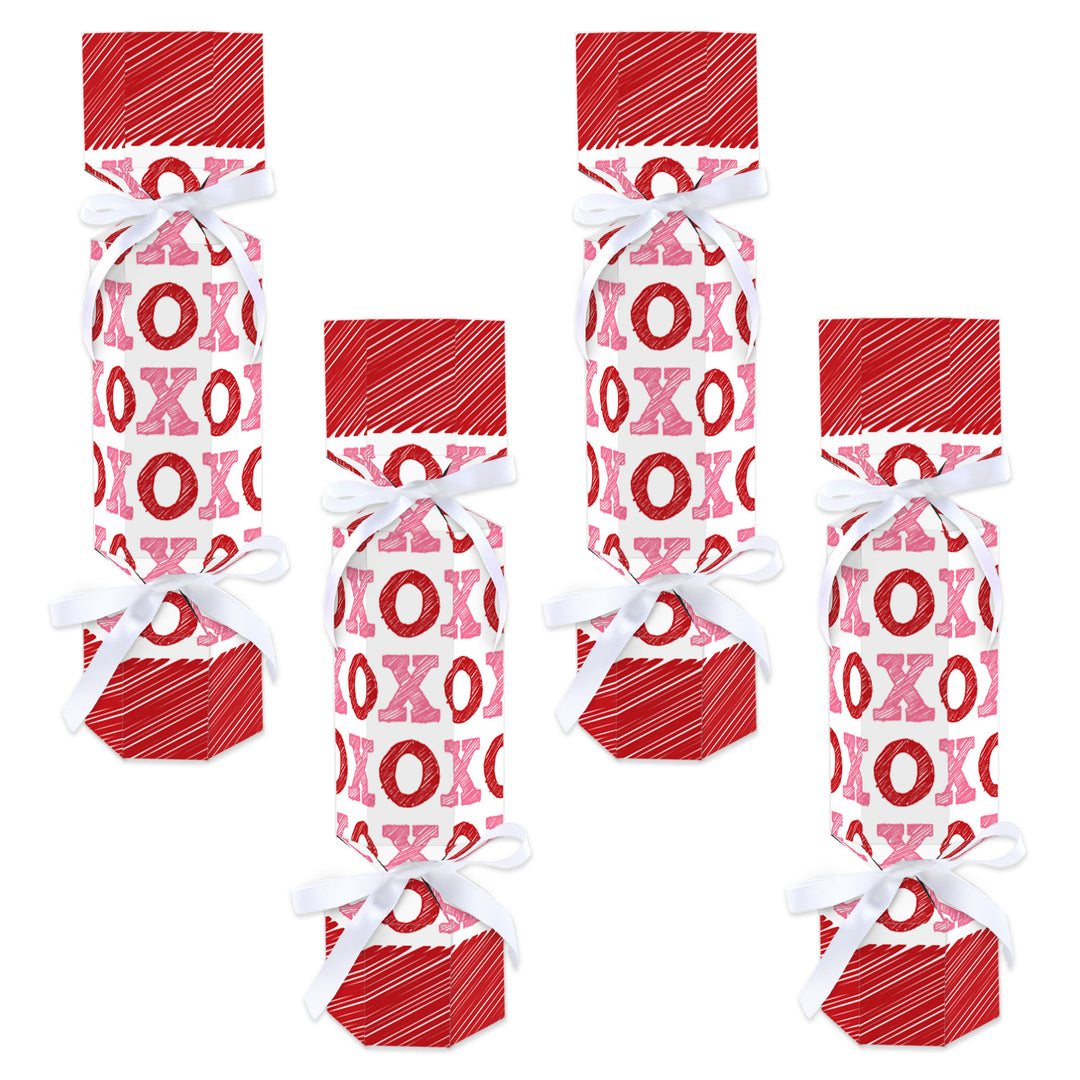 A set of 12 flat cardboard party crackers with a pink and red 'conversation hearts' pattern and white satin ribbons.