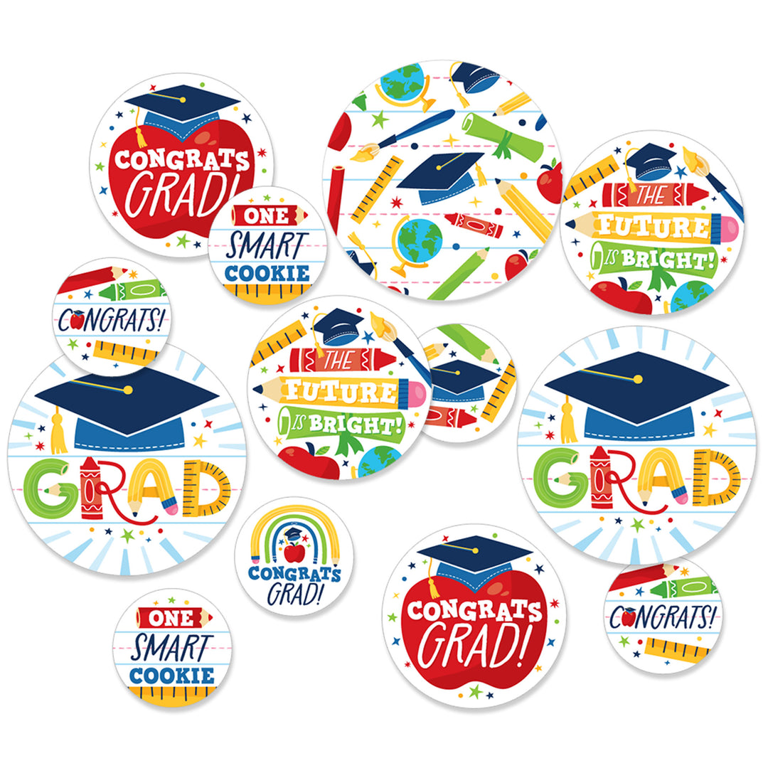 Assorted round confetti pieces with graduation-themed designs including graduation caps and Congrats Grad text in various sizes.