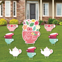 A set of colorful yard signs featuring floral patterns and tea party themed characters, including a large cup with the text 'Let's Par-Tea', displayed on a lawn.