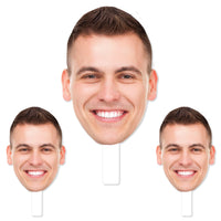 A set of three custom photo props featuring a smiling face, with one large head cutout and two smaller heads, all in white. Head on a stick
