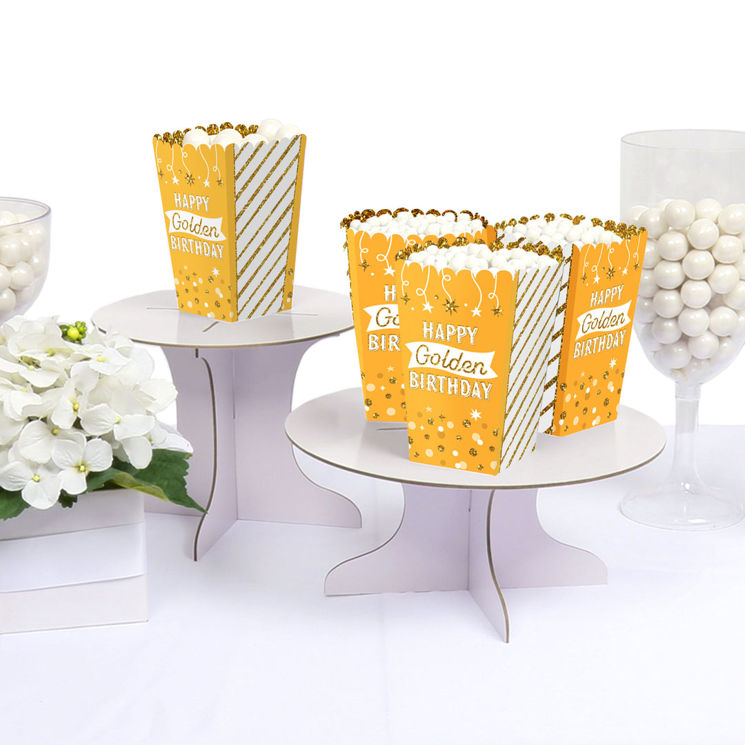 Golden Birthday favor boxes displayed on party table