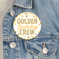 Golden Birthday buttons pinned on shirts and party favors