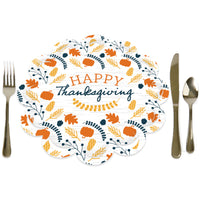 A round paper charger with a 'Happy Thanksgiving' text surrounded by fall-themed decorations, placed on a white surface with a fork on the left and a knife on the right.
