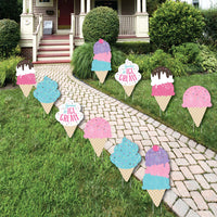 A set of colorful 'Scoop Up The Fun - Ice Cream' lawn decorations displayed on a grassy area in front of a house, consisting of various ice cream cone shapes with sprinkles and the text 'ICE CREAM'.
