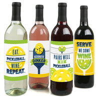 Four wine bottle labels with different pickleball-themed designs, including phrases such as 'EAT. PICKLEBALL.