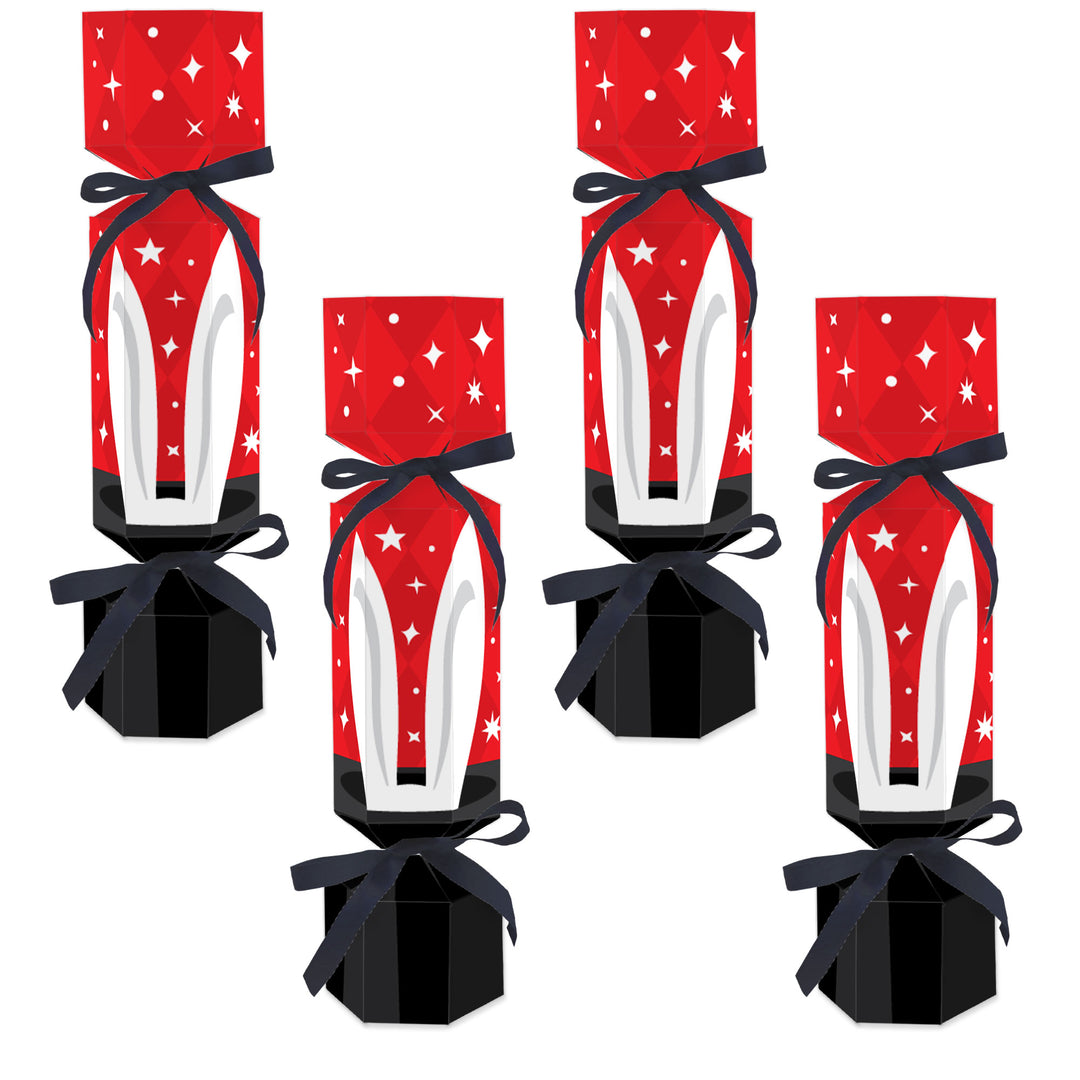 Four assembled DIY cracker boxes with red and white design, black ribbon, and star decorations.
