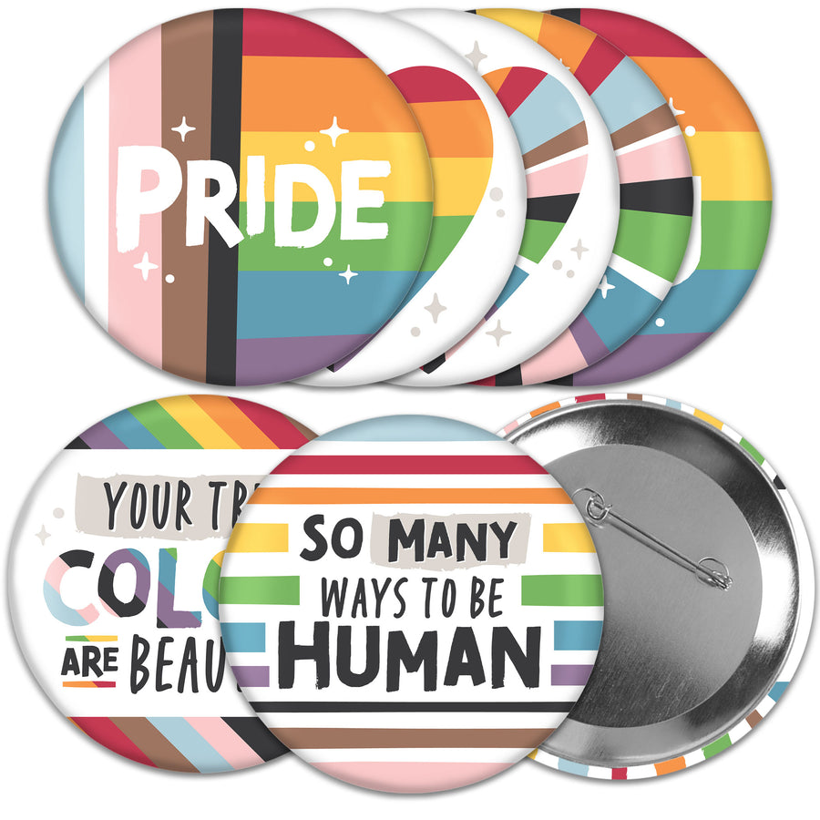 A set of 8 pinback buttons with various colorful backgrounds and text related to LGBTQ+ pride, including 'PRIDE' and 'So Many Ways to Be Human'.
