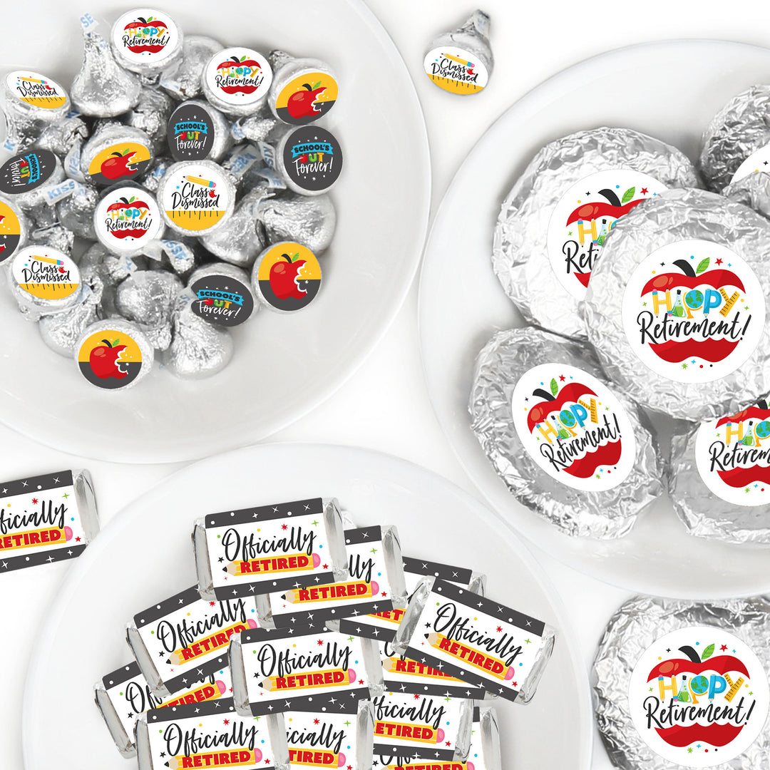 An assortment of candy wrappers and stickers with retirement themed designs in a color scheme predominantly featuring gray, with additional colors yellow, red, and white. The design includes text elements such as 'Happy Retirement' and apple graphics.