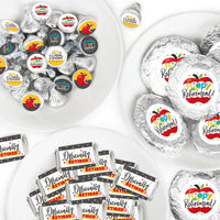 An assortment of candy wrappers and stickers with retirement themed designs in a color scheme predominantly featuring gray, with additional colors yellow, red, and white. The design includes text elements such as 'Happy Retirement' and apple graphics.