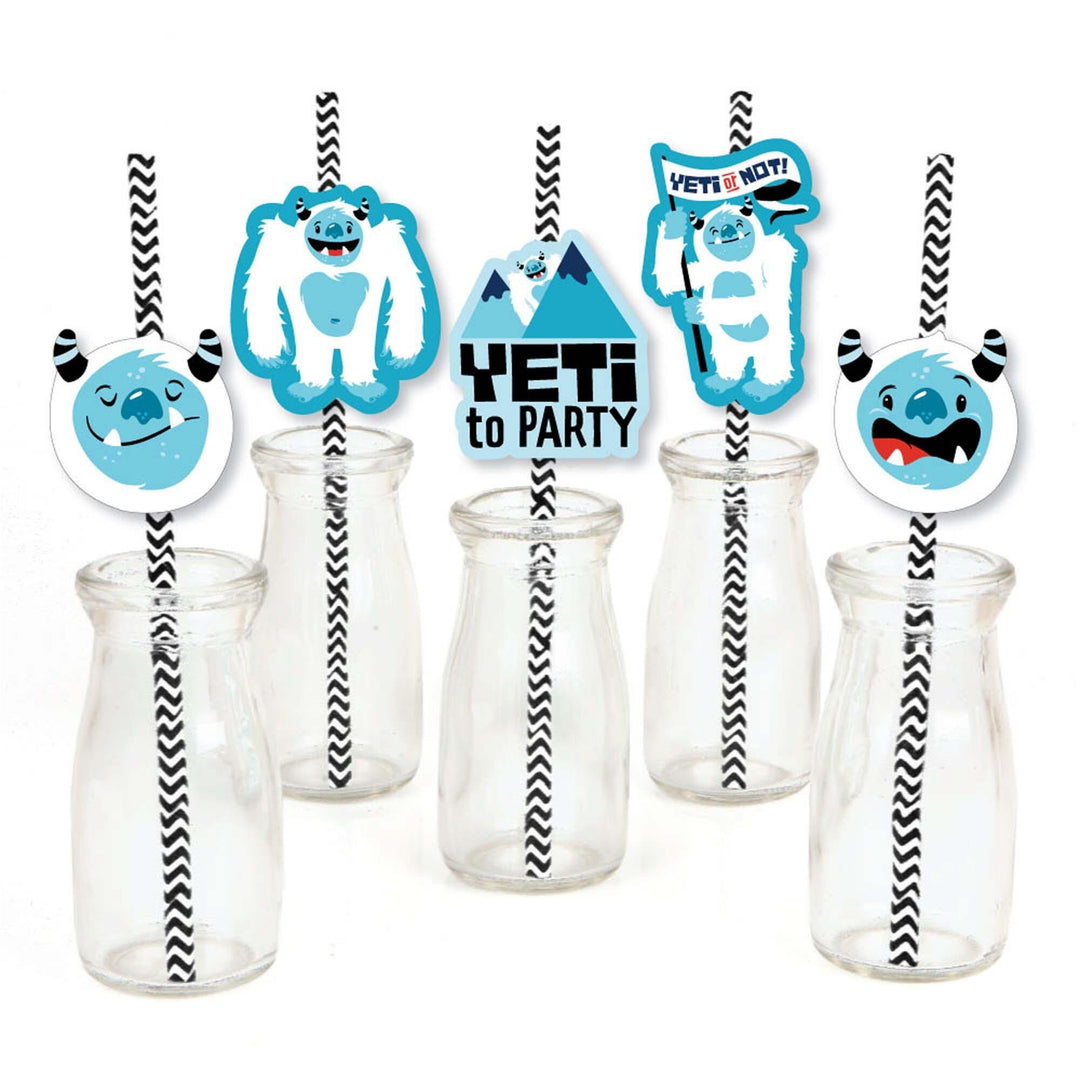 A set of decorative paper straws with blue yeti characters attached to them, displayed in front of clear drinking straws.