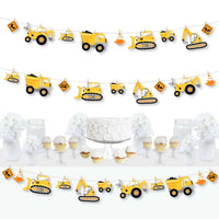 A completed clothespin garland banner with construction party zone theme, displayed at a party setting with construction vehicles and road signs.