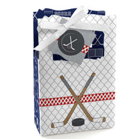 A favor box with a hockey theme, featuring a white ribbon, blue and red accents, and an emblem with a hockey stick and puck.
