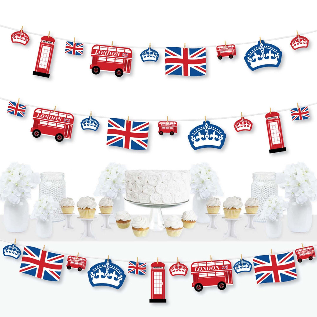 A completed clothespin garland banner featuring British themed cutouts including Union Jack flags and iconic London symbols displayed across a table.