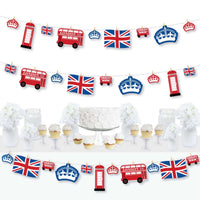 A completed clothespin garland banner featuring British themed cutouts including Union Jack flags and iconic London symbols displayed across a table.