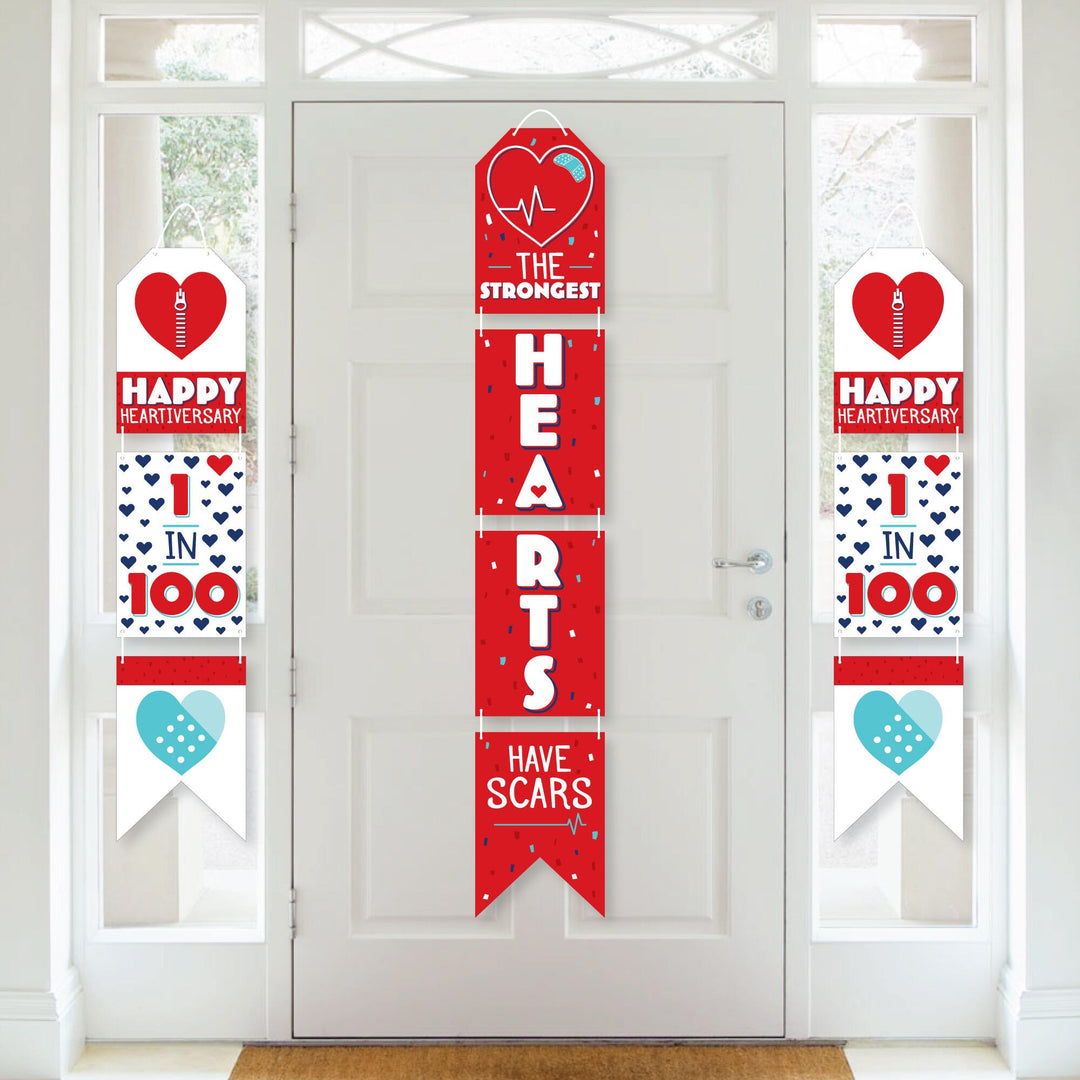 A series of vertical paper banners with red, white, and blue colors and heart motifs, celebrating 'Happy Heartiversary'.