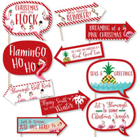 A collection of 10 printed and cut photo booth props featuring flamingo-themed Christmas phrases and characters.