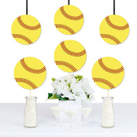 A set of yellow softball-shaped decorations with red stitching are displayed hanging from strings, arranged in front of a white floral arrangement, presumably part of a party decoration set.