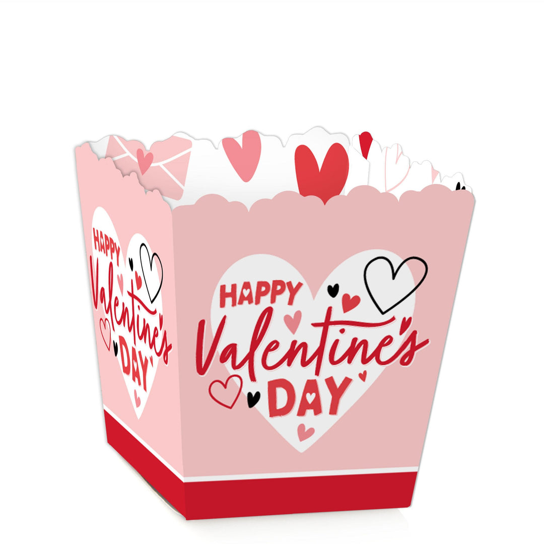 A small square-shaped, pink Valentine's Day-themed candy box with 'Happy Valentine's Day' text and heart designs.