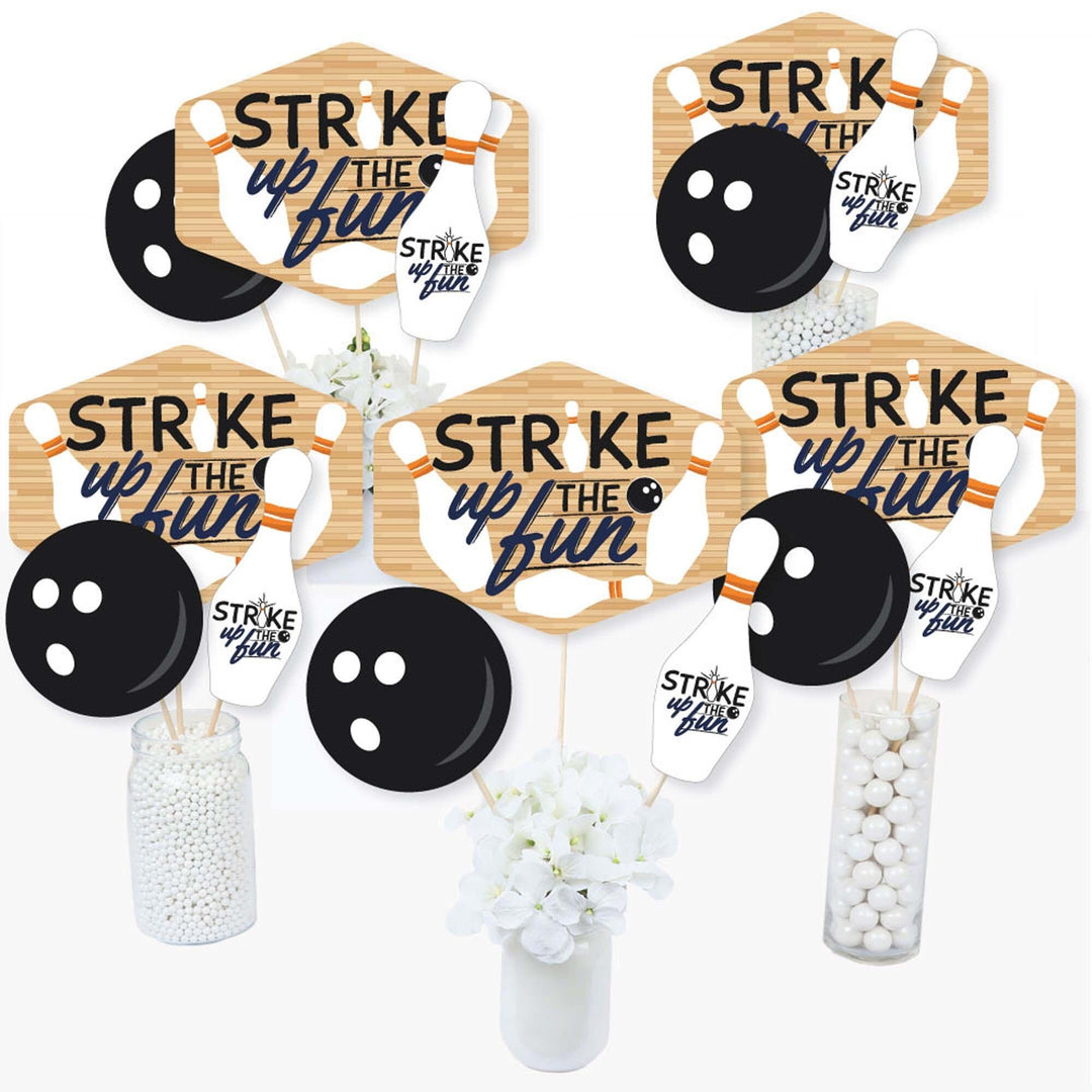 A set of centerpiece sticks with bowling-themed decorations including cutouts of bowling pins, balls, and text that say 'Strike Up the Fun'.