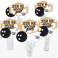 A set of centerpiece sticks with bowling-themed decorations including cutouts of bowling pins, balls, and text that say 'Strike Up the Fun'.