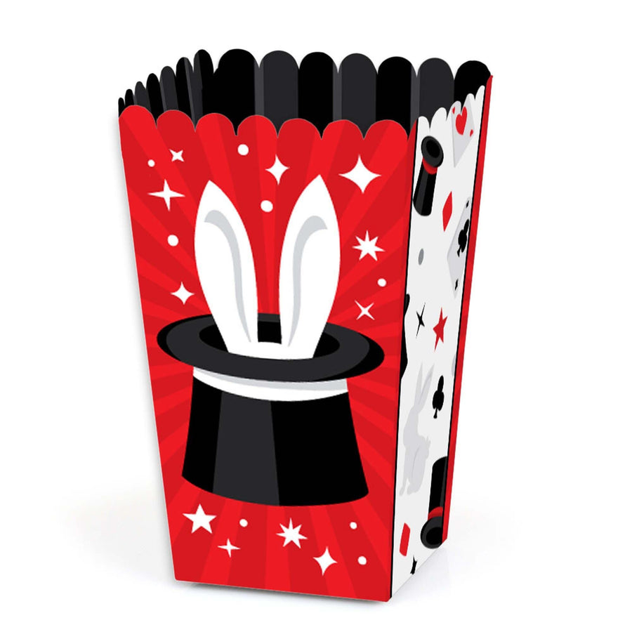 A red popcorn treat box with a white magicians hat and rabbit ears design, along with white stars and a black background pattern.