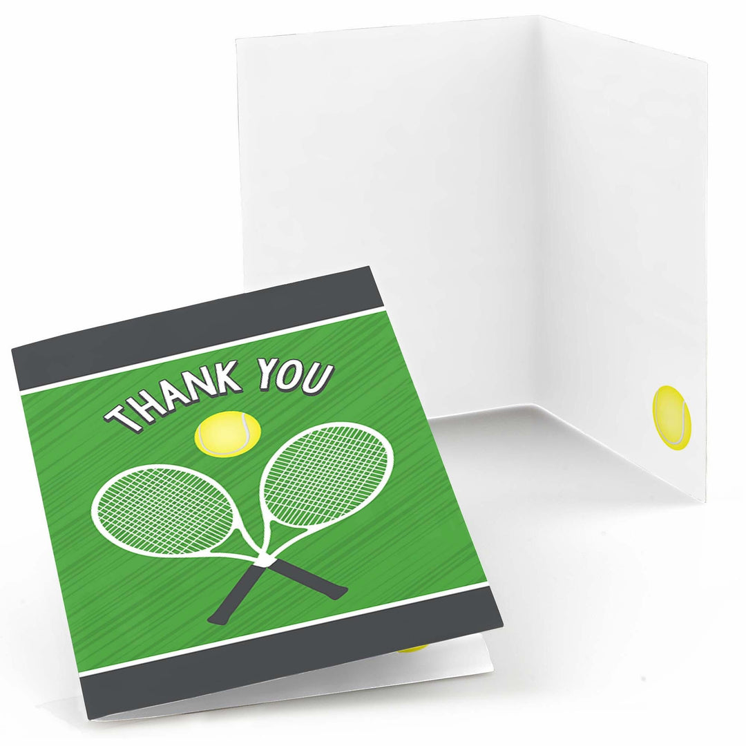 A folded thank you card with a green background featuring illustrations of two tennis rackets and a tennis ball, and the text 'THANK YOU'. A white envelope is shown behind the folded card.