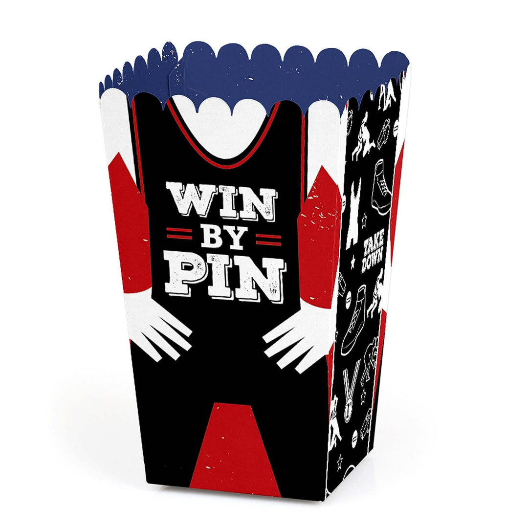 A colorful popcorn treat box with a wrestling theme, featuring text and graphics related to the wrestling sport.
