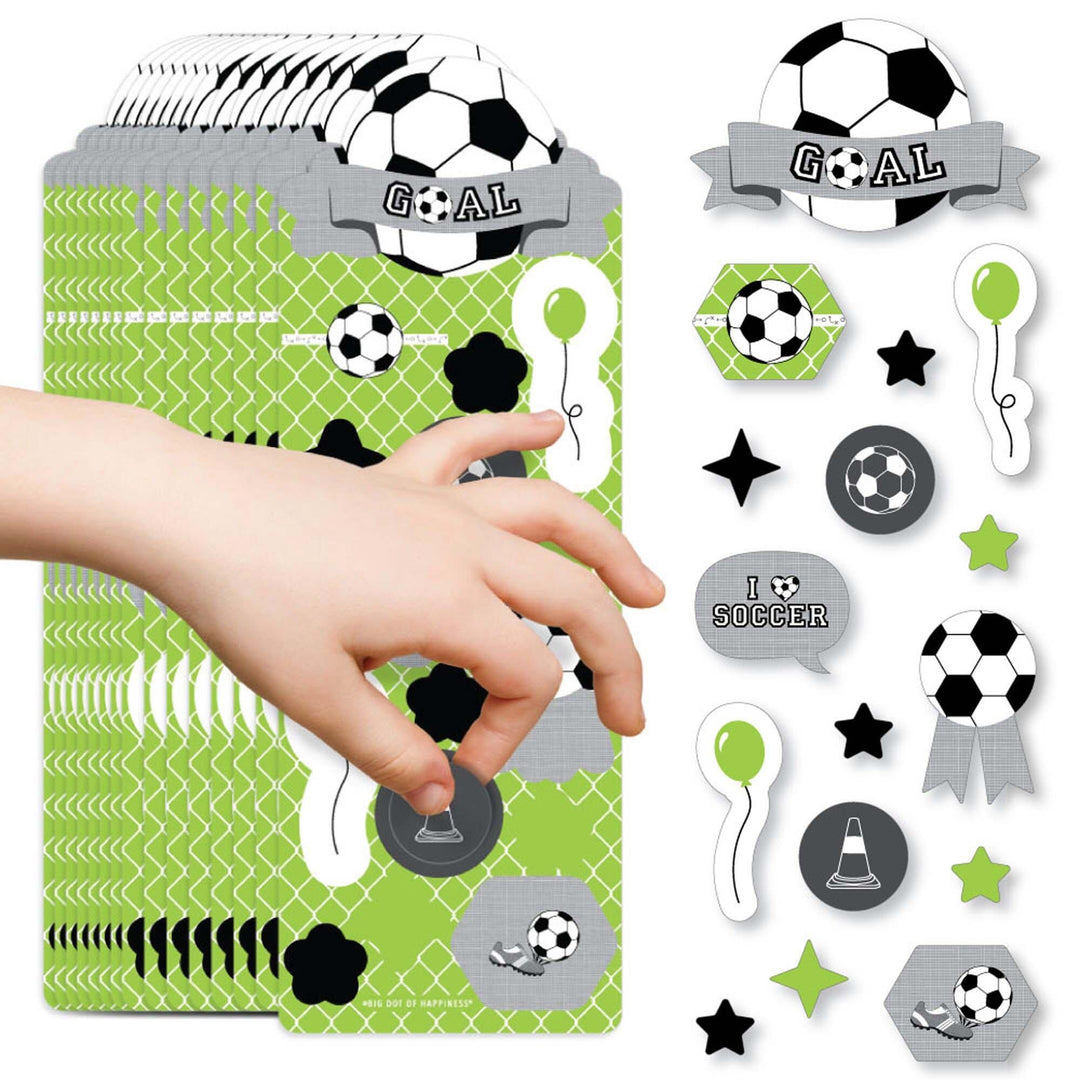 A collection of soccer-themed stickers including balls, stars, and text that reads 'GOAAAL!' displayed on a child's hand.