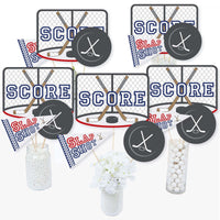 A set of hockey-themed centerpiece sticks with 'SCORE' and 'SLAP SHOT' text and hockey puck designs, intended for use at baby shower or birthday parties.
