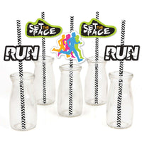 A set of decorative straws for a running-themed party, featuring paper cutouts with the text 'SET THE PACE' and the word 'RUN' in various colors attached to black and white striped straws, displayed in clear bottles.
