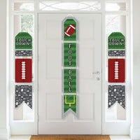 A set of vertical hanging paper door banners for a football-themed party, featuring numbers and football graphics in green, white, and red colors displayed on a white door.